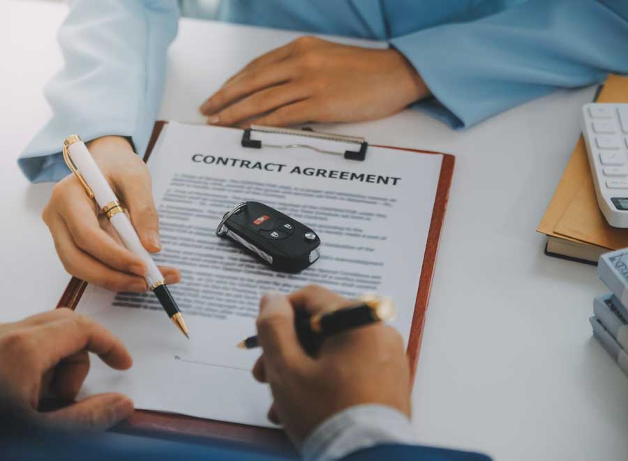 Appraisal Clause Auto Insurance concept showing two parties signing a vehicle contract agreement with car keys on the document, representing insurance claim evaluation and dispute resolution process.