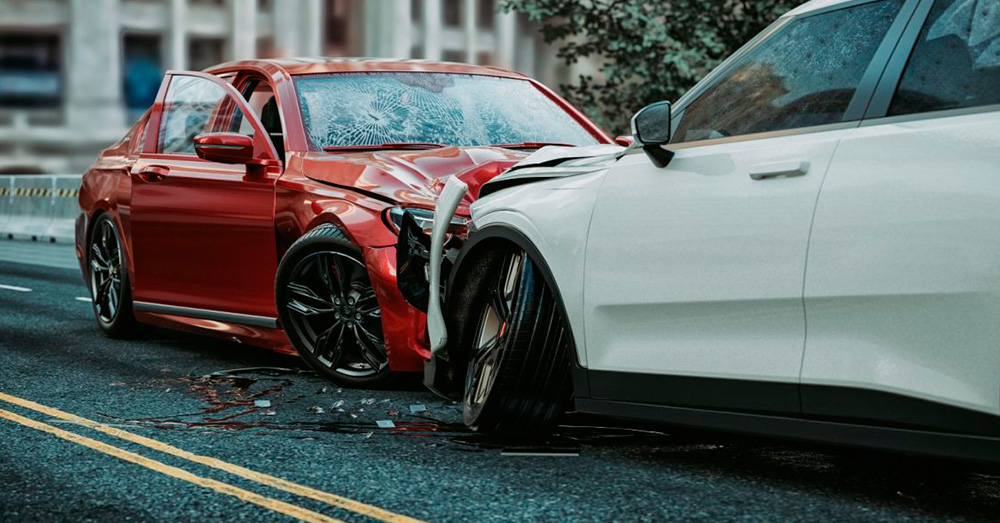 Head-on car accident involving a red sedan and white SUV with severe front-end damage on a city street, illustrating insurance assessment and Diminished Value Claim Nebraska after a collision.